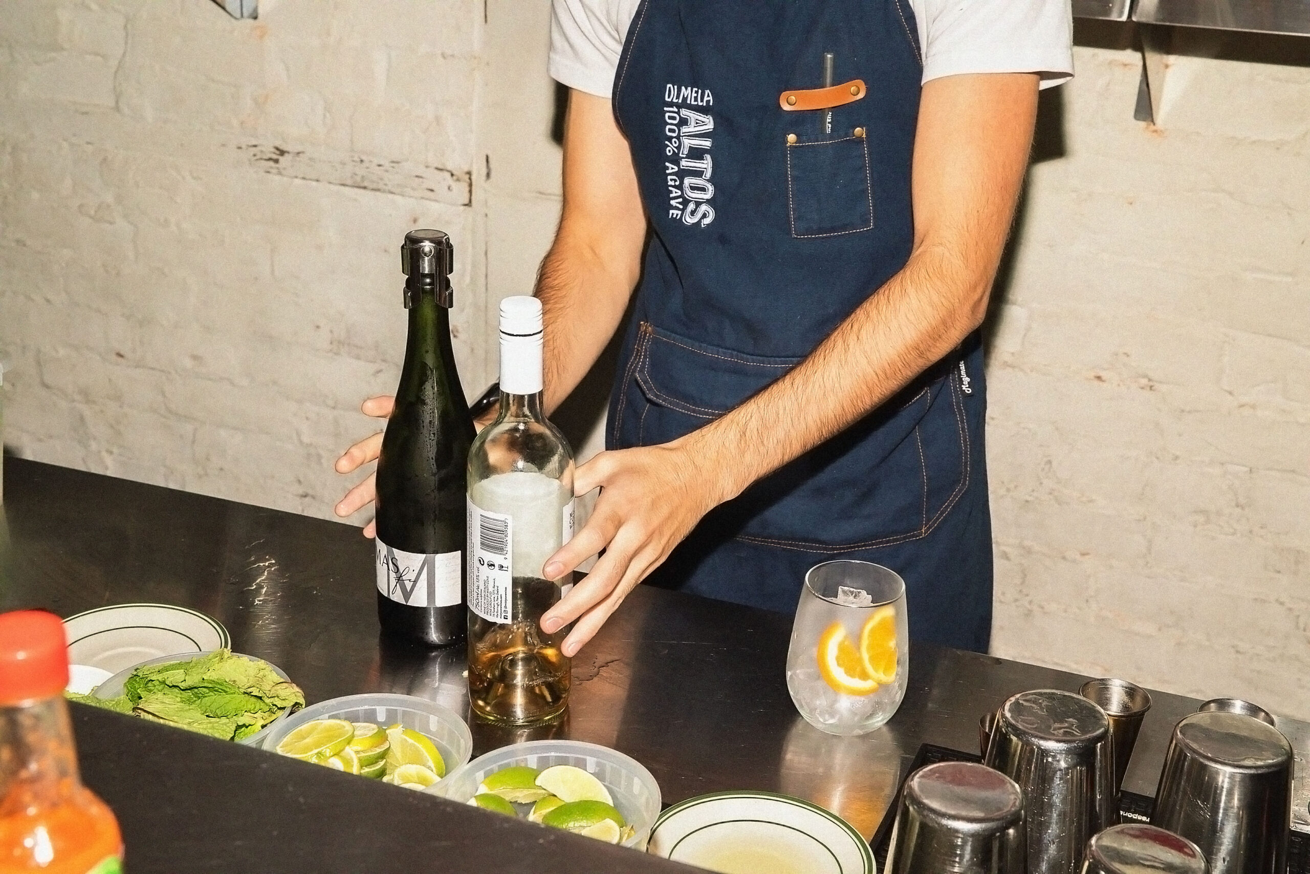 Bartender mixing drinks at restaurant bar